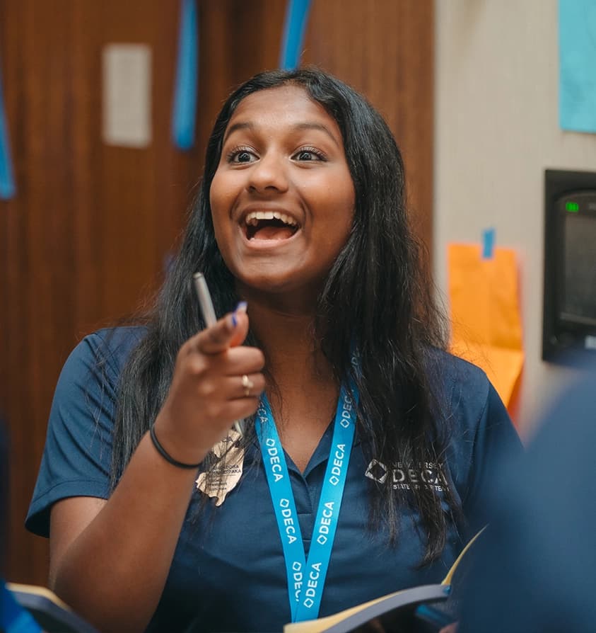 A PA DECA advisor coaching a student